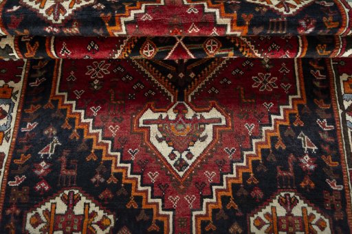 Corner detail of 2000s Shiraz rug showing border pattern and Wool pile