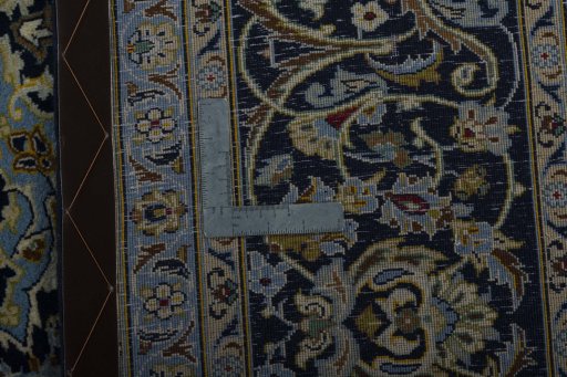 Backside of handmade New Kashan rug showing knot structure and weave density