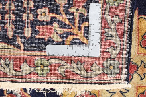 Surface texture of 1920s Agra rug with natural Wool and intricate pattern