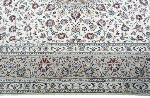 Corner detail of 2000s Kashan rug showing border pattern and Wool pile