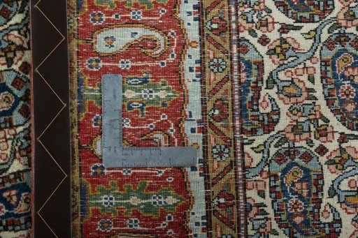 Close-up detail of 1950s Ghom rug from Iran / Persia showing Wool weave