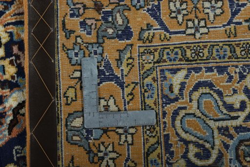 Surface texture of 1970s Ghom rug with natural Wool and intricate pattern