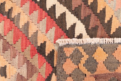 Close-up detail of 1989s Kilim Traditional rug from Iran / Persia showing Wool weave