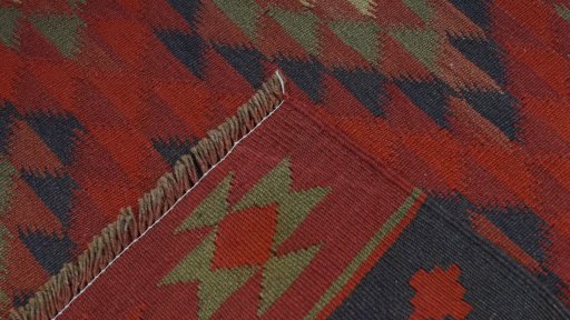 Close-up detail of New Kilim Traditional rug from Iran / Persia showing Wool weave