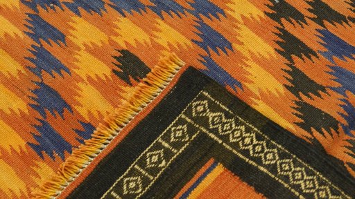 Close-up detail of New Kilim Traditional rug from Iran / Persia showing Wool weave