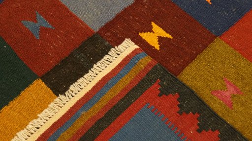 Close-up detail of New Kilim Traditional rug from Iran / Persia showing Wool weave