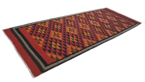 Close-up detail of New Kilim Traditional rug from Iran / Persia showing Wool weave