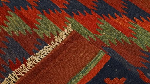 Close-up detail of New Kilim Traditional rug from Iran / Persia showing Wool weave