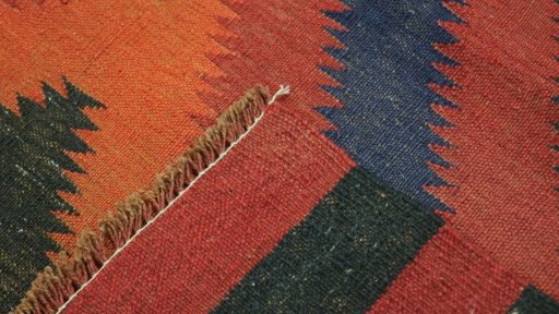 Close-up detail of New Kilim Traditional rug from Iran / Persia showing Wool weave