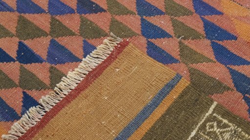 Close-up detail of New Kilim Traditional rug from Iran / Persia showing Wool weave
