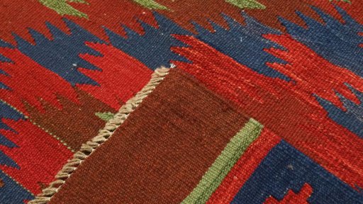 Close-up detail of New Kilim Traditional rug from Iran / Persia showing Wool weave