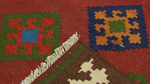 Close-up detail of New Kilim Traditional rug from Iran / Persia showing Wool weave