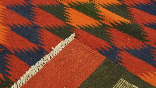 Close-up detail of New Kilim Traditional rug from Iran / Persia showing Wool weave