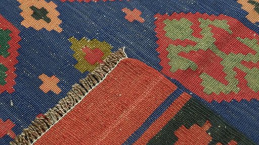 Close-up detail of New Kilim Traditional rug from Iran / Persia showing Wool weave