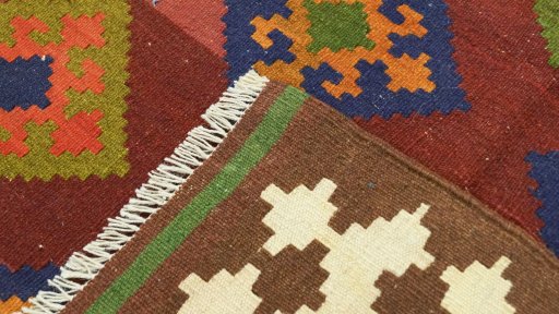 Close-up detail of New Kilim Traditional rug from Iran / Persia showing Wool weave