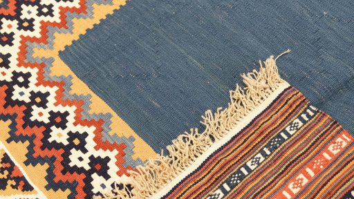 Close-up detail of New Kilim Traditional rug from Iran / Persia showing Wool weave