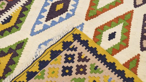 Close-up detail of New Kilim Traditional rug from Iran / Persia showing Wool weave