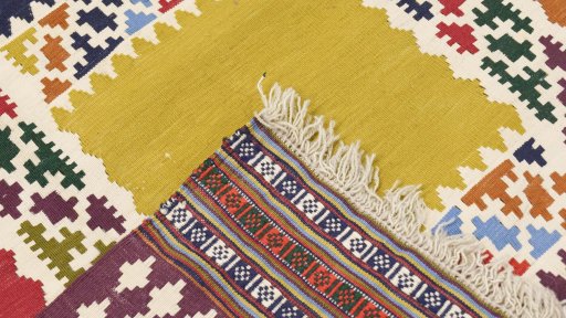 Close-up detail of New Kilim Traditional rug from Iran / Persia showing Wool weave