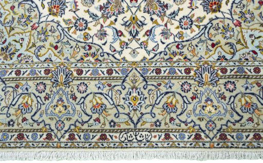 Corner detail of 2000s Kashan rug showing border pattern and Cork pile