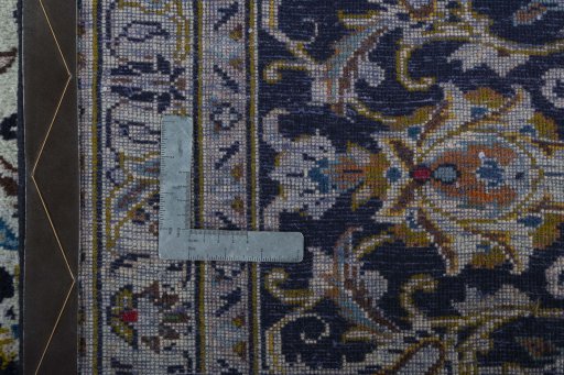 Backside of handmade 2000s Kashan rug showing knot structure and weave density