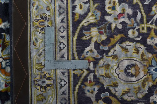 Backside of handmade 2000s Kashan rug showing knot structure and weave density