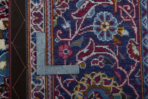 Backside of handmade New Kashan rug showing knot structure and weave density