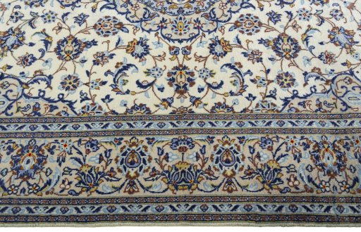 Corner detail of 2000s Kashan rug showing border pattern and Wool pile