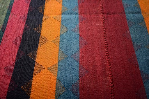 Backside of handmade 2000s Kilim Jajim rug showing knot structure and weave density