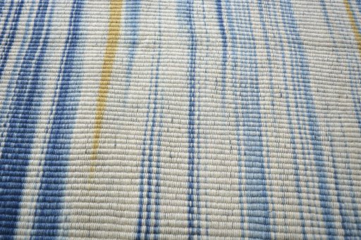 Backside of handmade New Modern Design rug showing knot structure and weave density