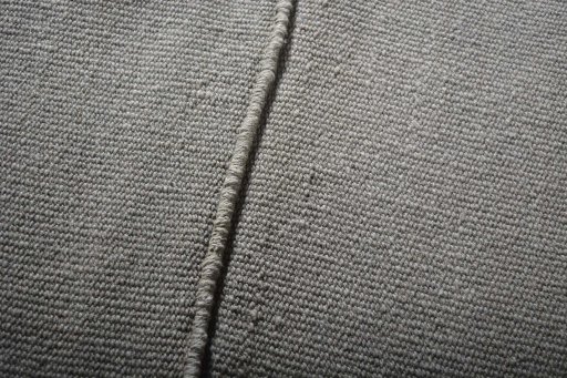 Backside of handmade New Modern Design rug showing knot structure and weave density
