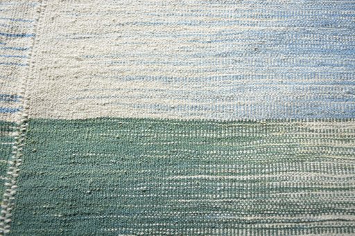 Backside of handmade New Modern Design rug showing knot structure and weave density