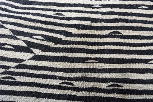 Backside of handmade New Modern Design rug showing knot structure and weave density