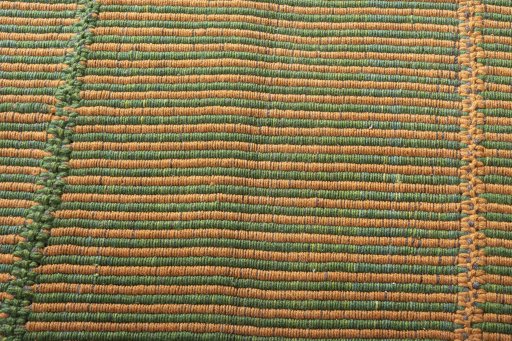 Backside of handmade New Modern Design rug showing knot structure and weave density