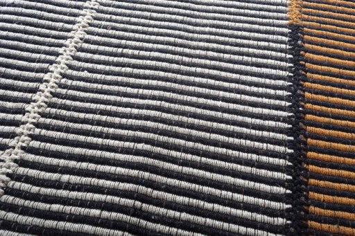 Backside of handmade New Modern Design rug showing knot structure and weave density