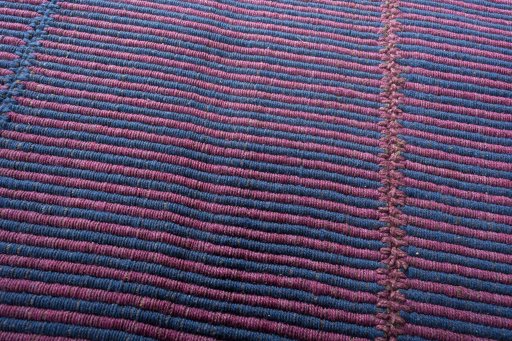 Backside of handmade New Modern Design rug showing knot structure and weave density