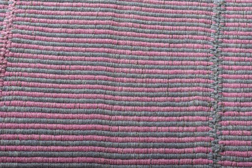 Backside of handmade New Modern Design rug showing knot structure and weave density