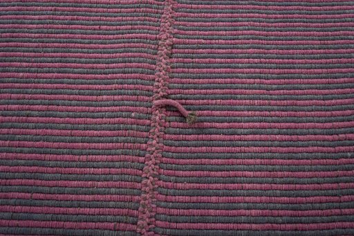 Backside of handmade New Modern Design rug showing knot structure and weave density