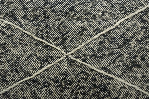 Backside of handmade New Modern Design rug showing knot structure and weave density