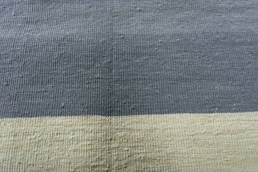 Backside of handmade New Modern Design rug showing knot structure and weave density