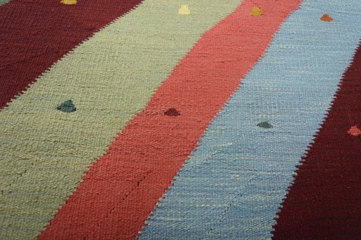 Backside of handmade New Modern Design rug showing knot structure and weave density