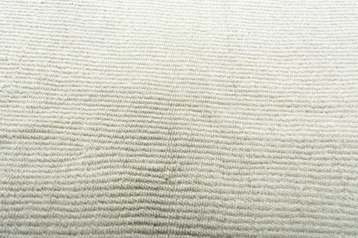 Backside of handmade New Modern Design rug showing knot structure and weave density