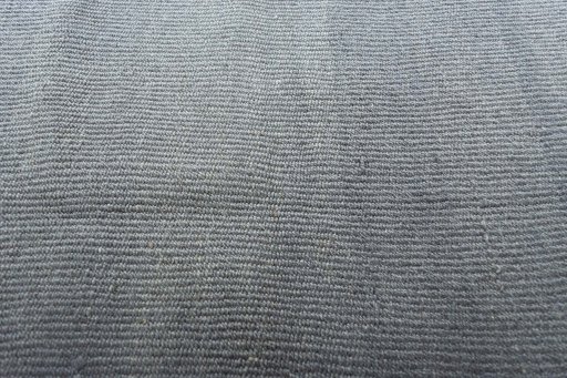 Backside of handmade New Modern Design rug showing knot structure and weave density