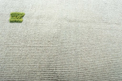 Backside of handmade New Modern Design rug showing knot structure and weave density