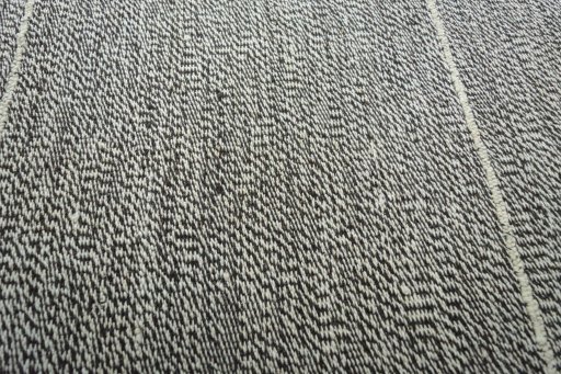 Backside of handmade New Modern Design rug showing knot structure and weave density