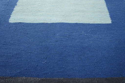 Backside of handmade New Modern Design rug showing knot structure and weave density