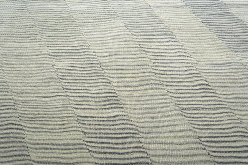 Backside of handmade New Modern Design rug showing knot structure and weave density