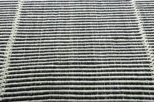 Backside of handmade New Modern Design rug showing knot structure and weave density