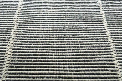 Backside of handmade New Modern Design rug showing knot structure and weave density