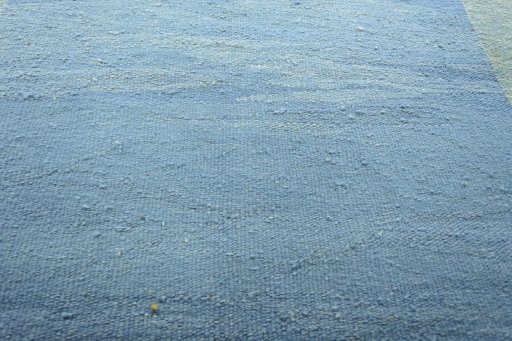 Backside of handmade New Modern Design rug showing knot structure and weave density