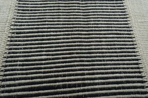 Backside of handmade New Modern Design rug showing knot structure and weave density